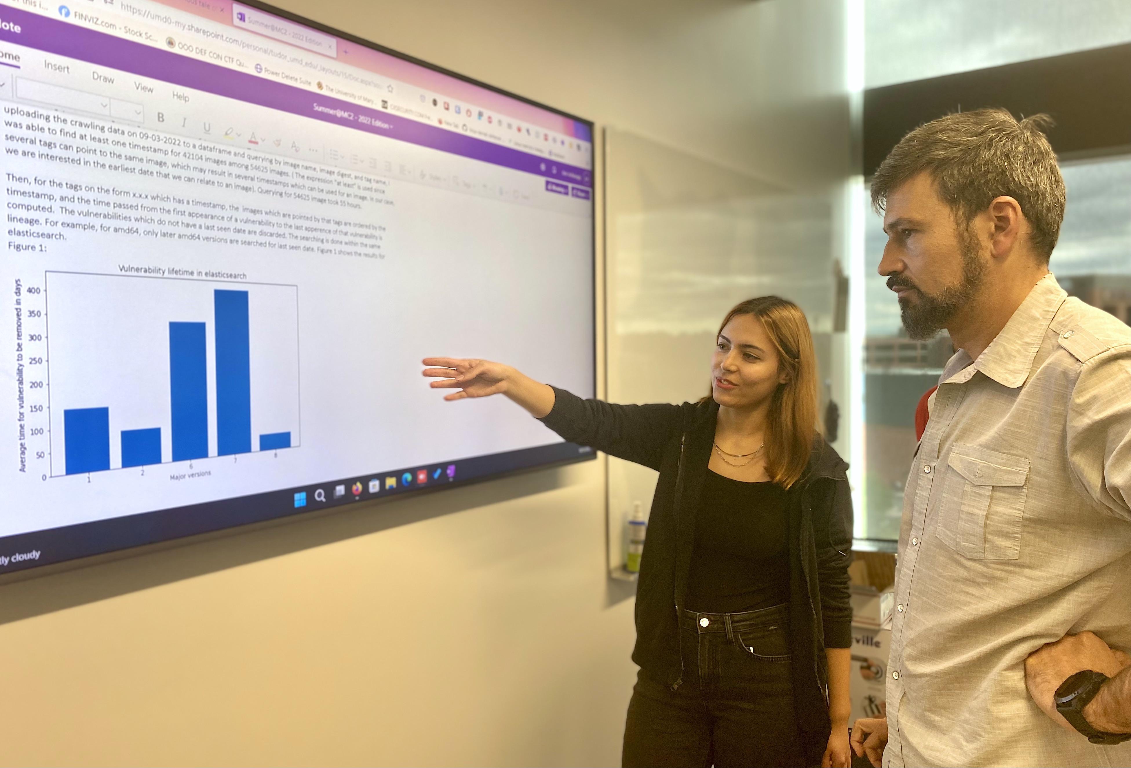 man and woman discussing cybersecurity data