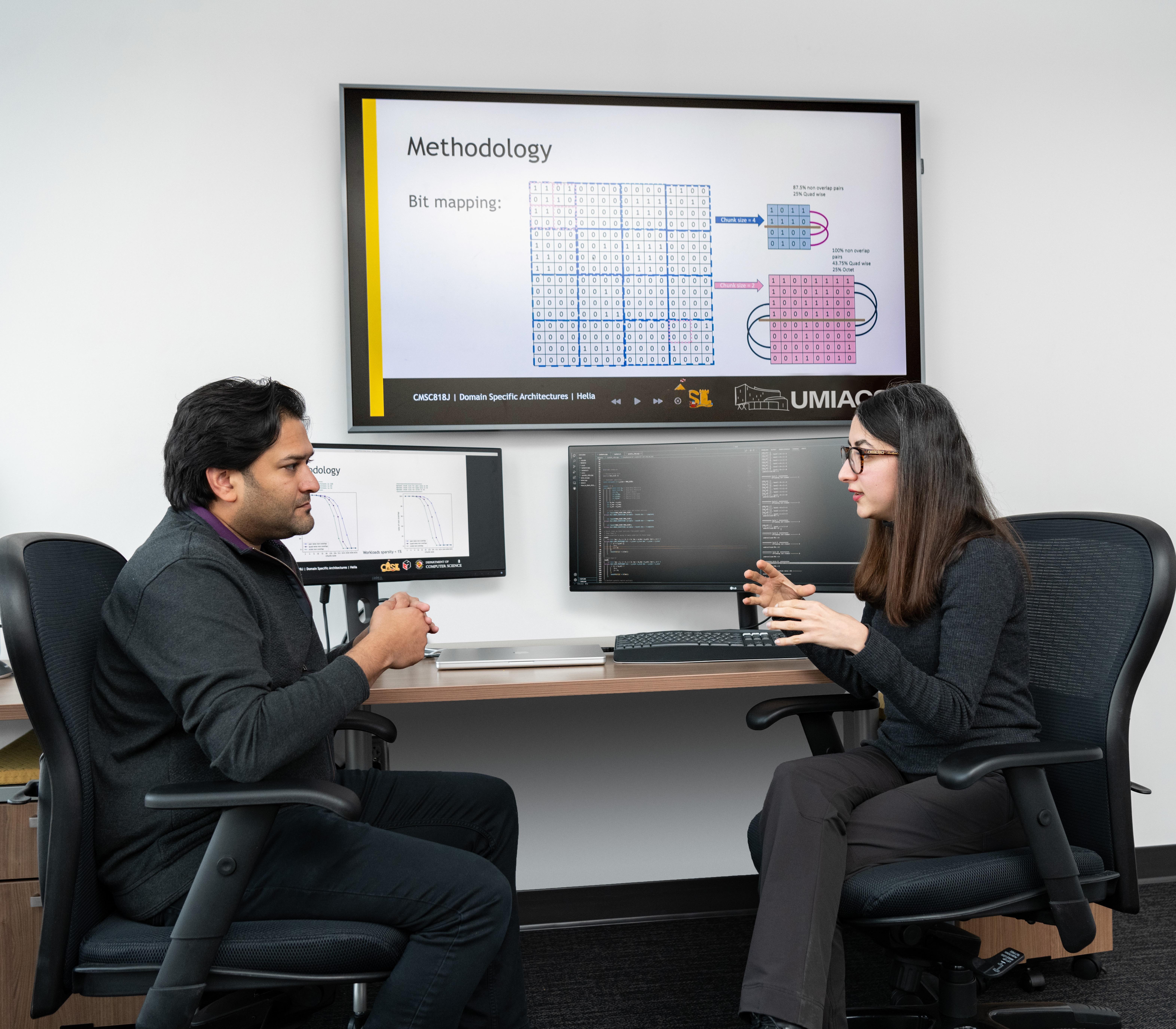 faculty talking in front of computers