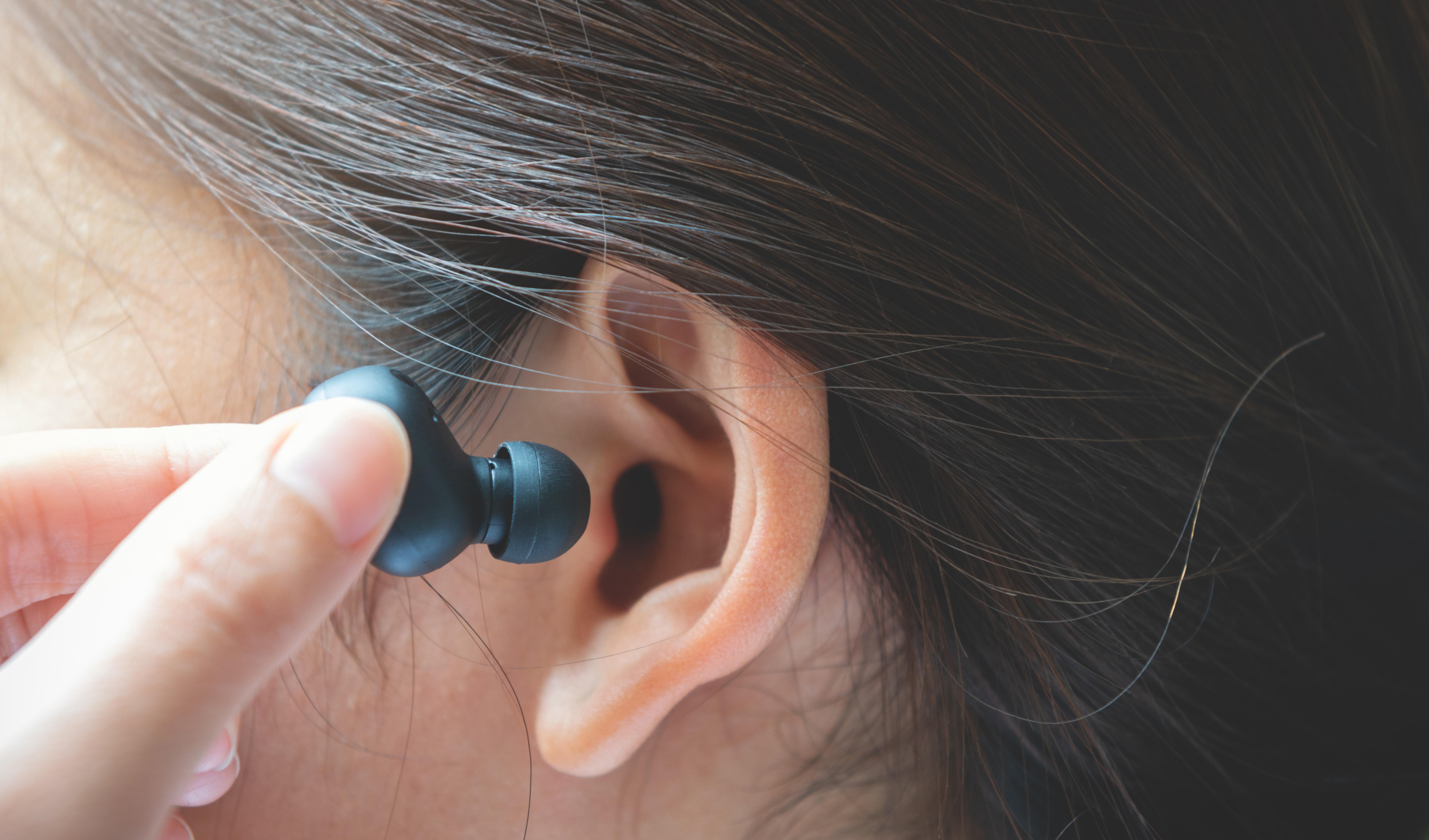 earbud being put in ear