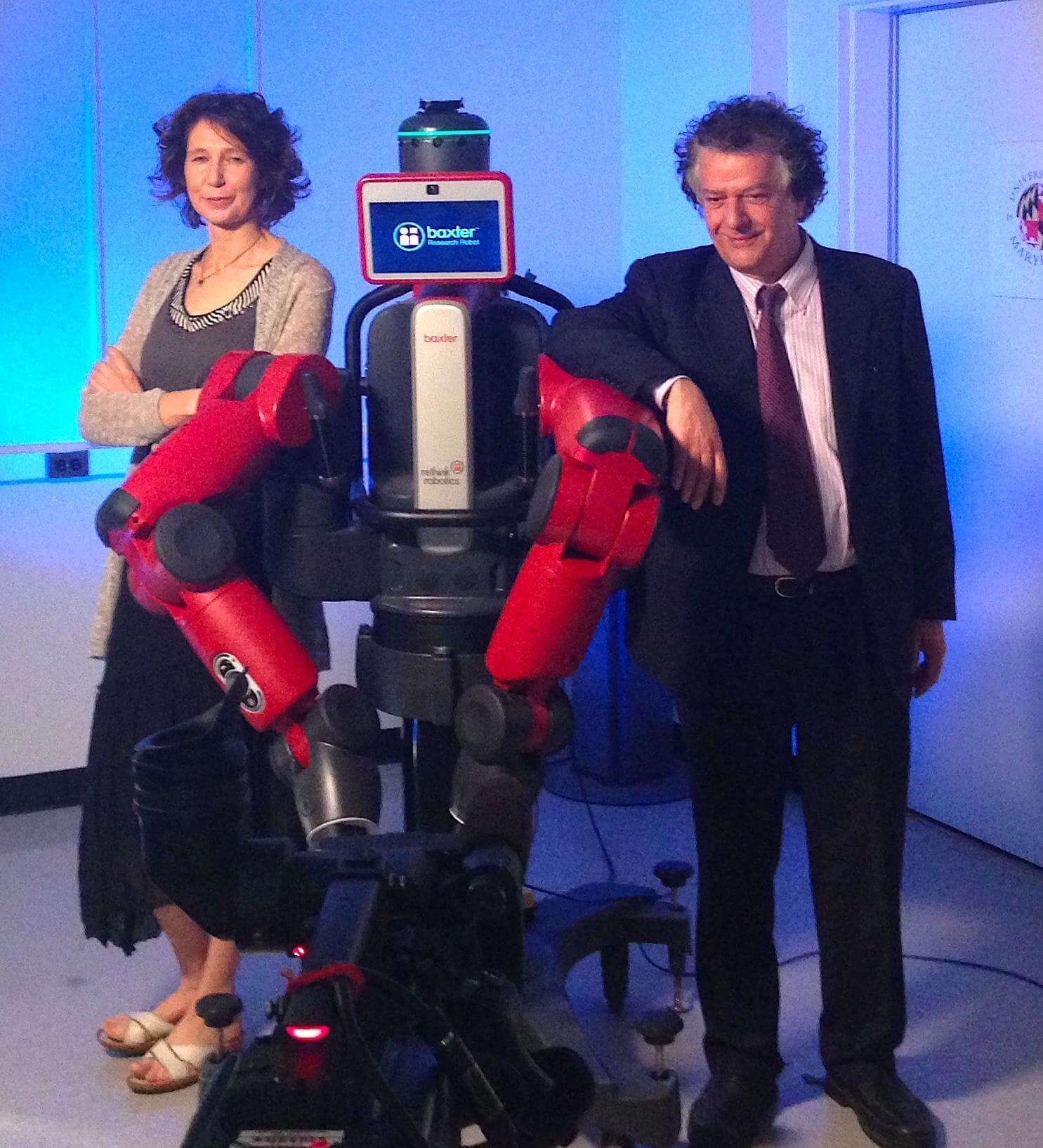 Photo of Cornelia Fermüller and Yiannis Aloimonos posing with a robot