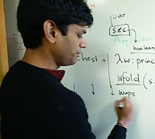 man at white board