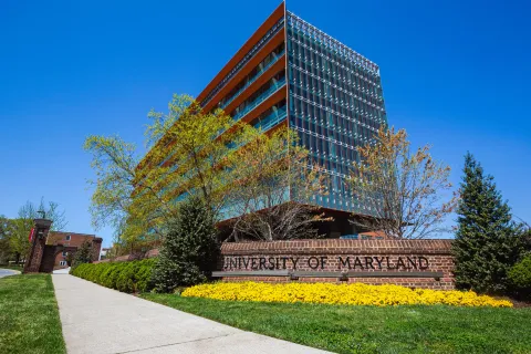 University of Maryland sign in front of glass building