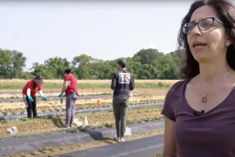 woman talking in front of agriculture field