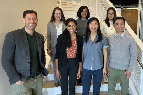 A photo of Tom Goldstein with the six awardees for the 2024 Rising Stars in Machine Learning program .