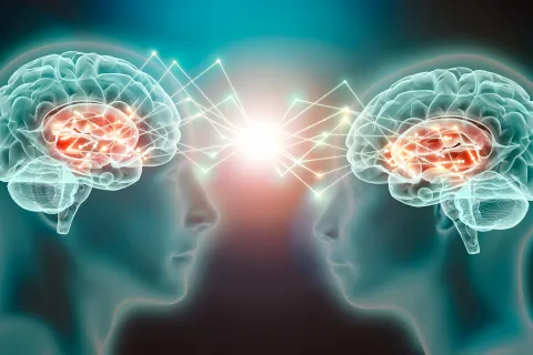 An image of two brains with zigzags connecting them.