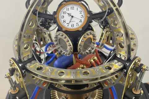 An eight-inch in diameter sculpture blending steampunk’s brass and gears with the mind-bending world of quantum physics.