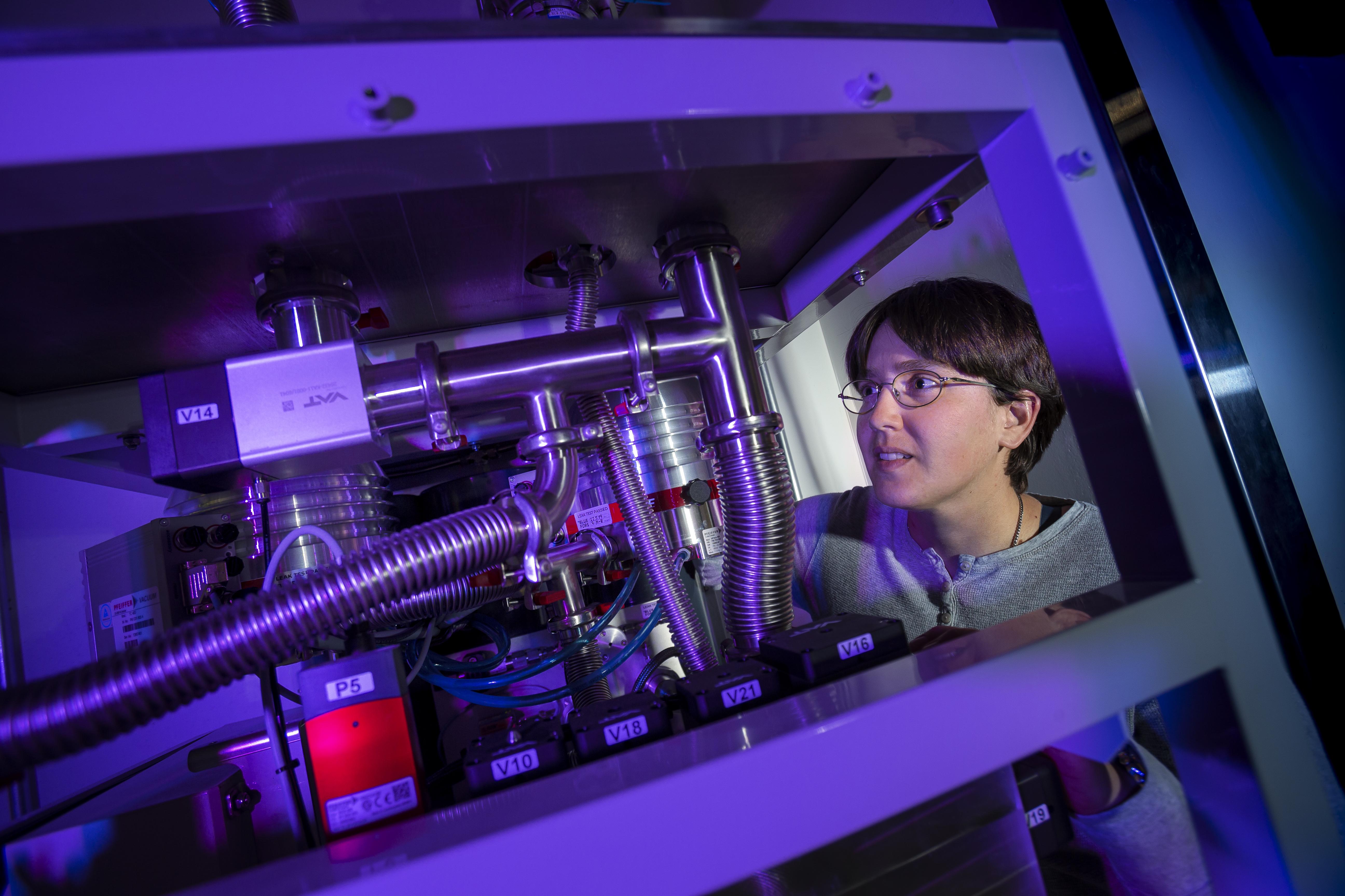 woman looking at quantum equipment