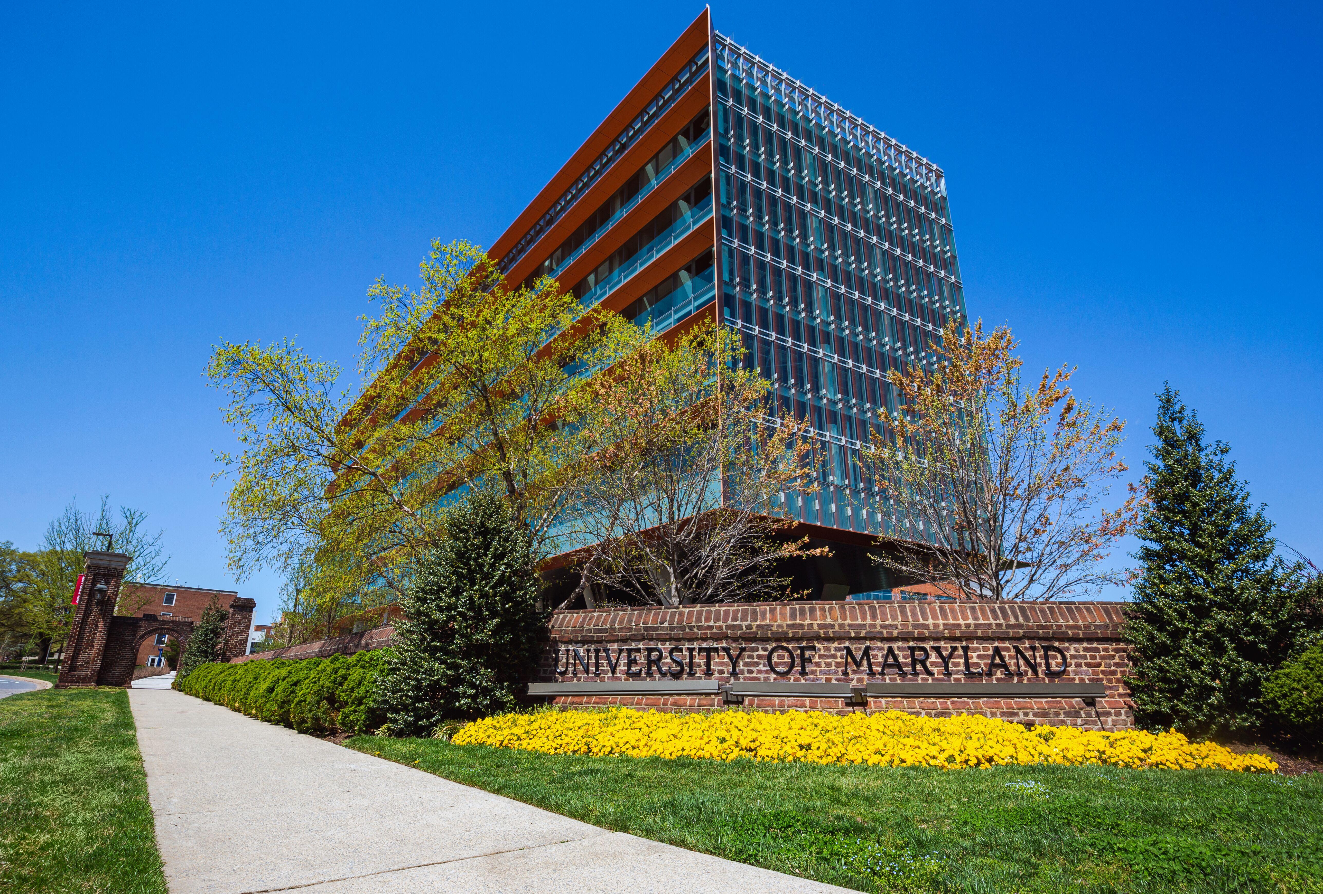 University of Maryland sign in front of glass building