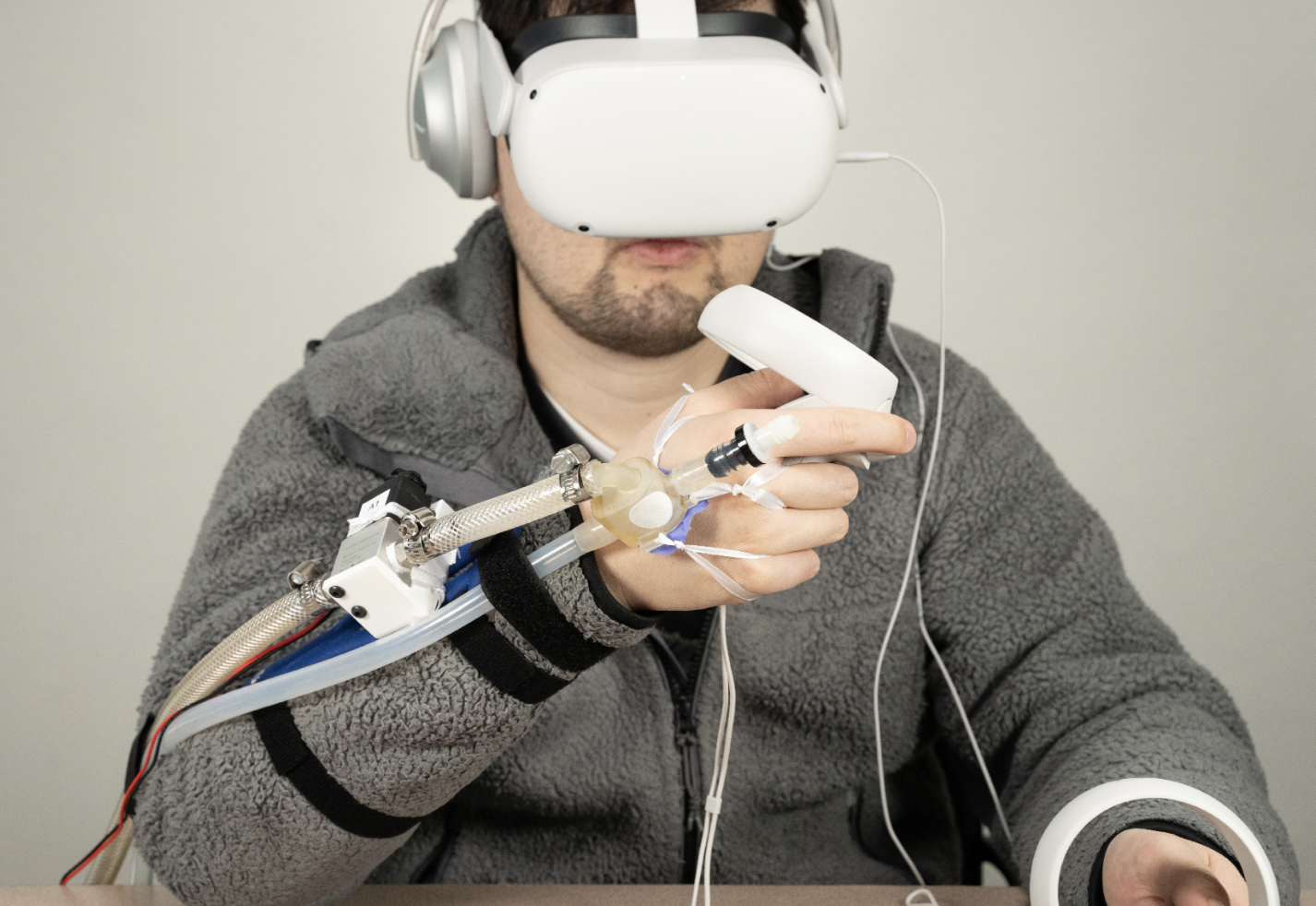 Photo of a person wearing a VR headset and the JetUnit attachment