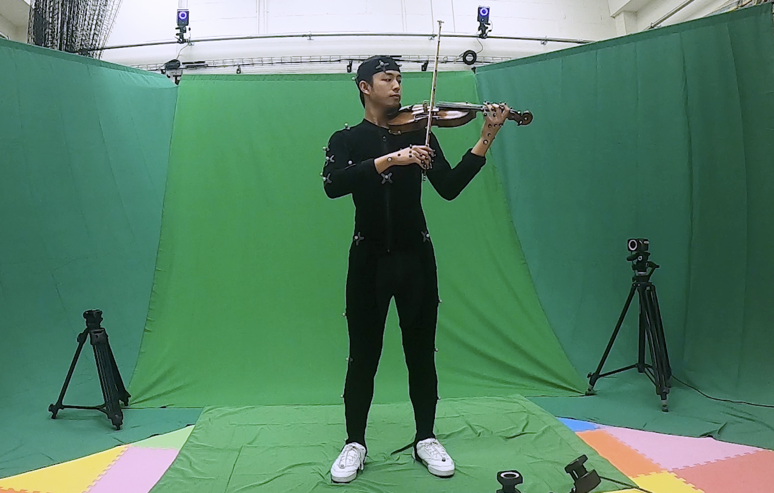 person playing violin against greenscreen