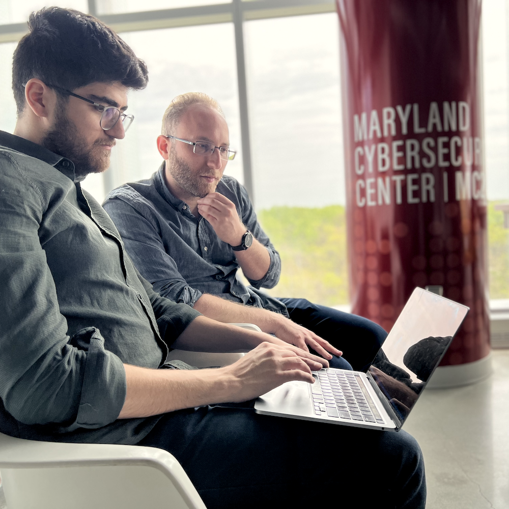 researchers talking by Maryland Cybersecurity Center column